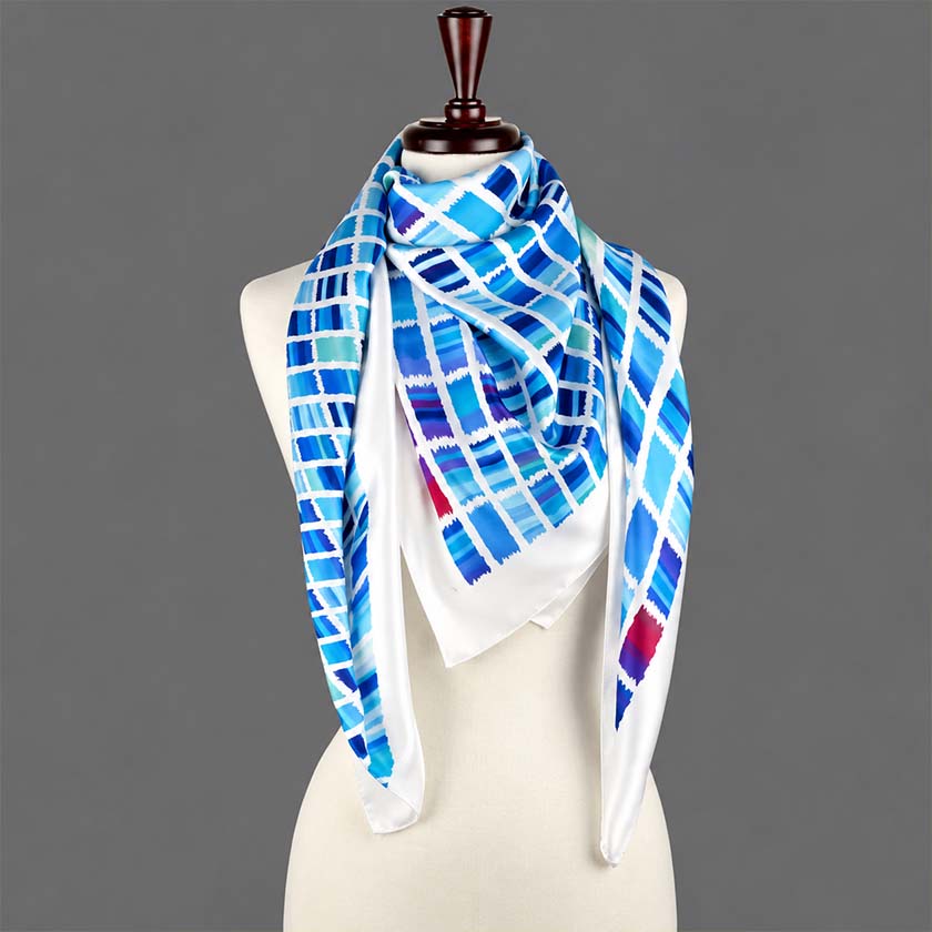 Ethnic teal and navy silk satin scarf by Anne Touraine Paris, displayed on a mannequin