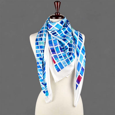 Ethnic teal and navy silk satin scarf by Anne Touraine Paris, displayed on a mannequin
