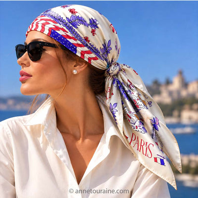 Beautiful dark hair woman, standing near by the sea. She is wearing on her head, knotted like pirat, an Anne Touraine Paris beige French silk scarf "Paris- New York".