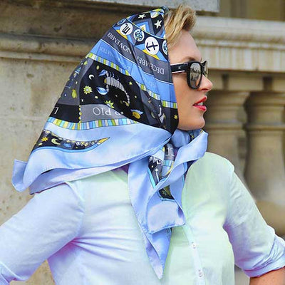 Astrology blue scarf featuring the twelve zodiac signs  by ANNE TOURAINE Paris™ scarves tied as a headscarf