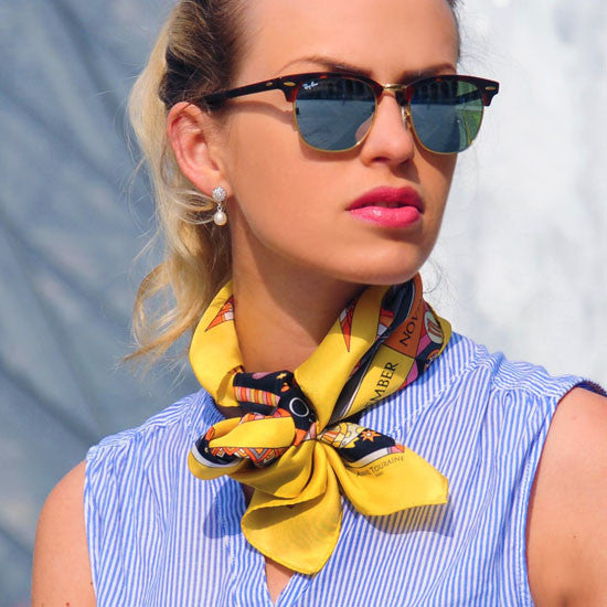 Astrology yellow and black scarf featuring the twelve zodiac signs  by ANNE TOURAINE Paris™ scarves tied as a neck scarf