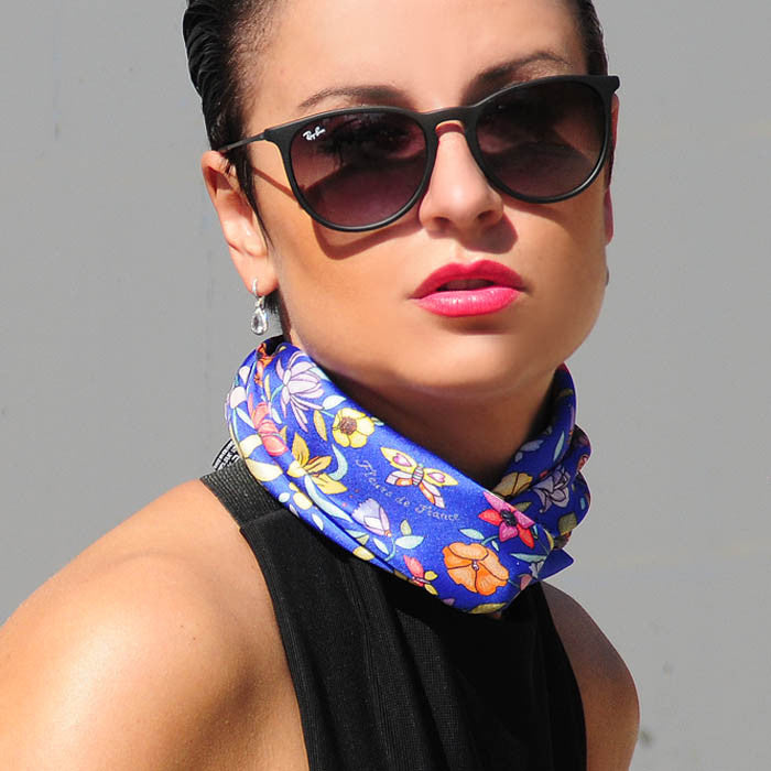 Floral scarves: blue floral silk scarf made in France by ANNE TOURAINE Paris™ scarves. Scarf tied around the neck in a double wrap.
