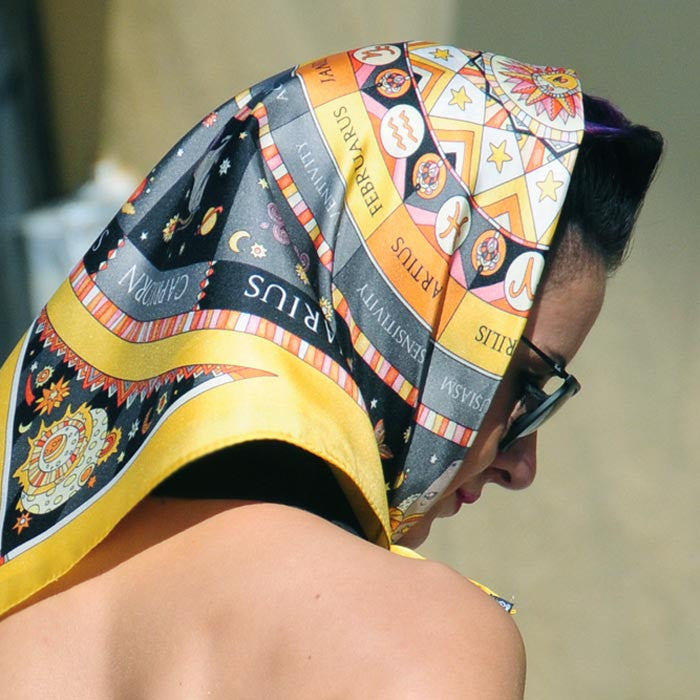 Astrology yellow and black scarf featuring the twelve zodiac signs by ANNE TOURAINE Paris™ scarves tied as a headscarf a la jackie kennedy